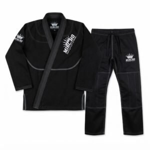 Black Jiu-Jitsu gi jacket and matching trousers set laid out flat.