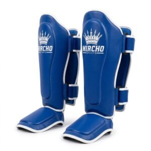 Blue MMA shin guards with white trim and dual rear closure straps displayed upright.