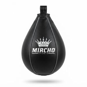 Black leather speed bag hanging against a white background for boxing training.