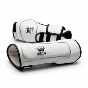 Pair of white martial arts forearm guards with black straps and gold piping against a white background.