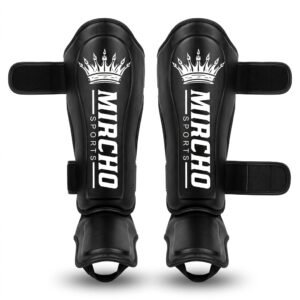 Pair of black martial arts shin guards with dual straps and instep padding.
